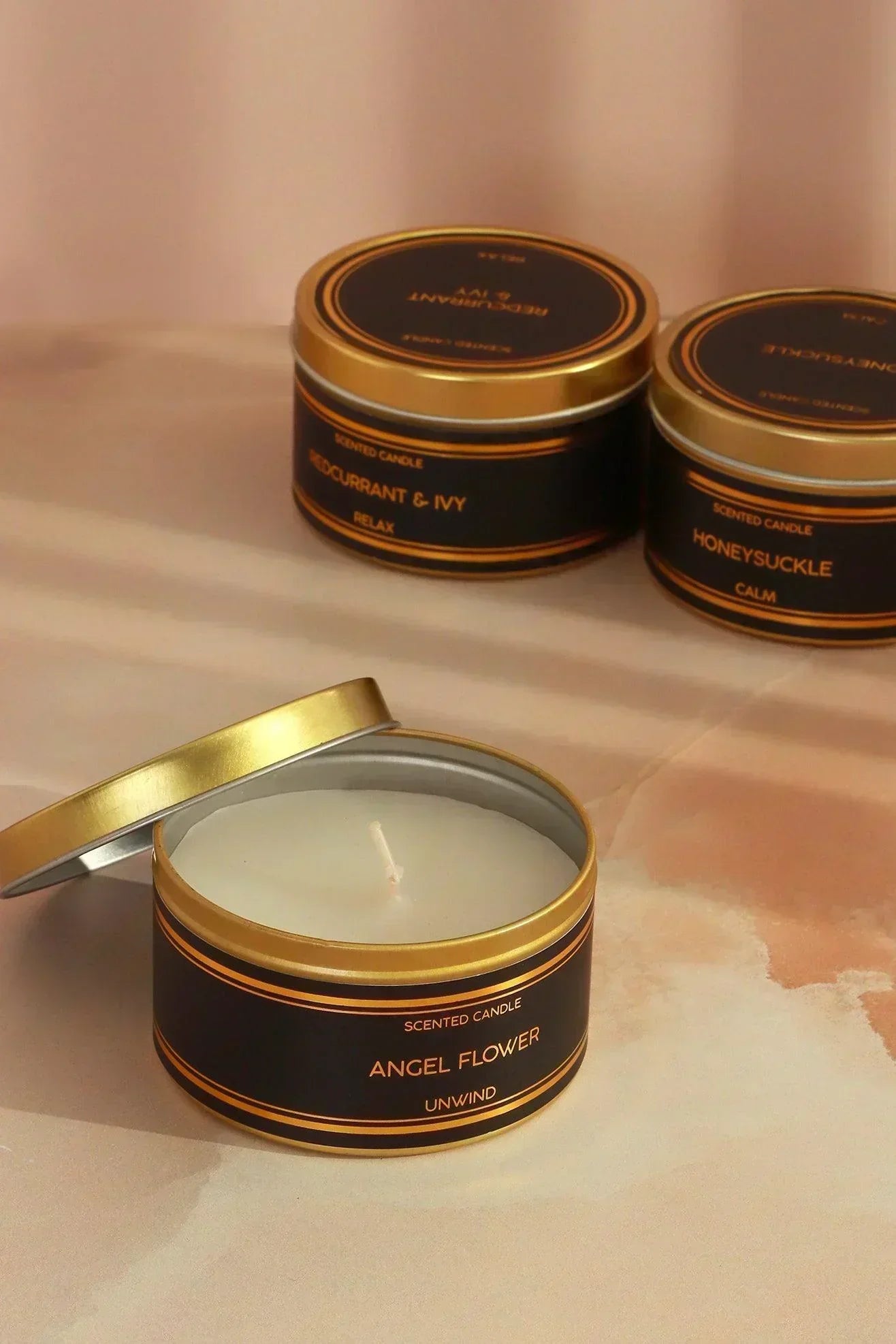 tranquessence-mood-scented-large-candle-collection-black-and-gold-tin-candle-in-angel-flower-honeysuckle-or-blackcurrant-and-ivy-g-decor-41703 - G Decor