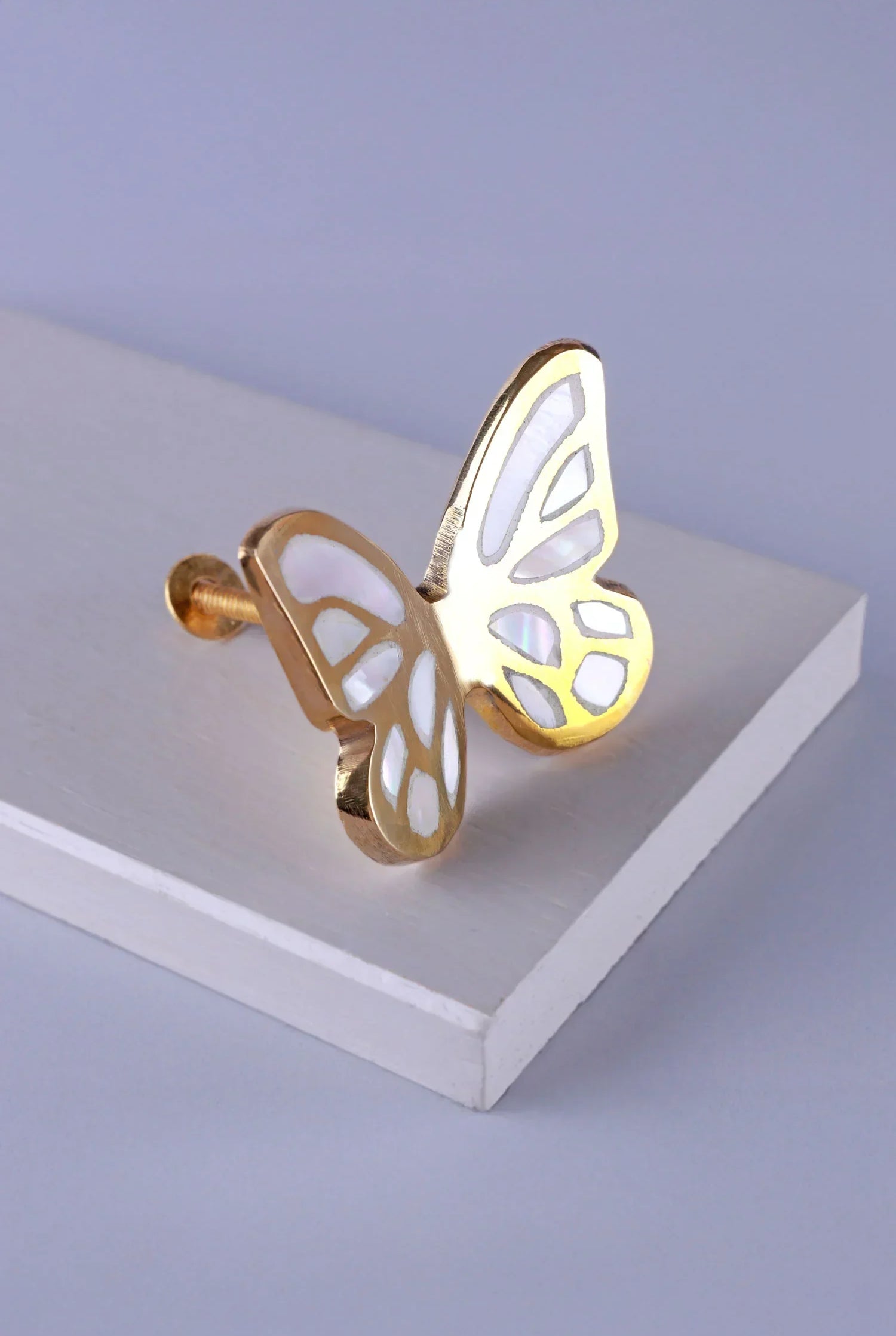 Gold butterfly cabinet knob with white inlay on display, G Decor luxury hardware