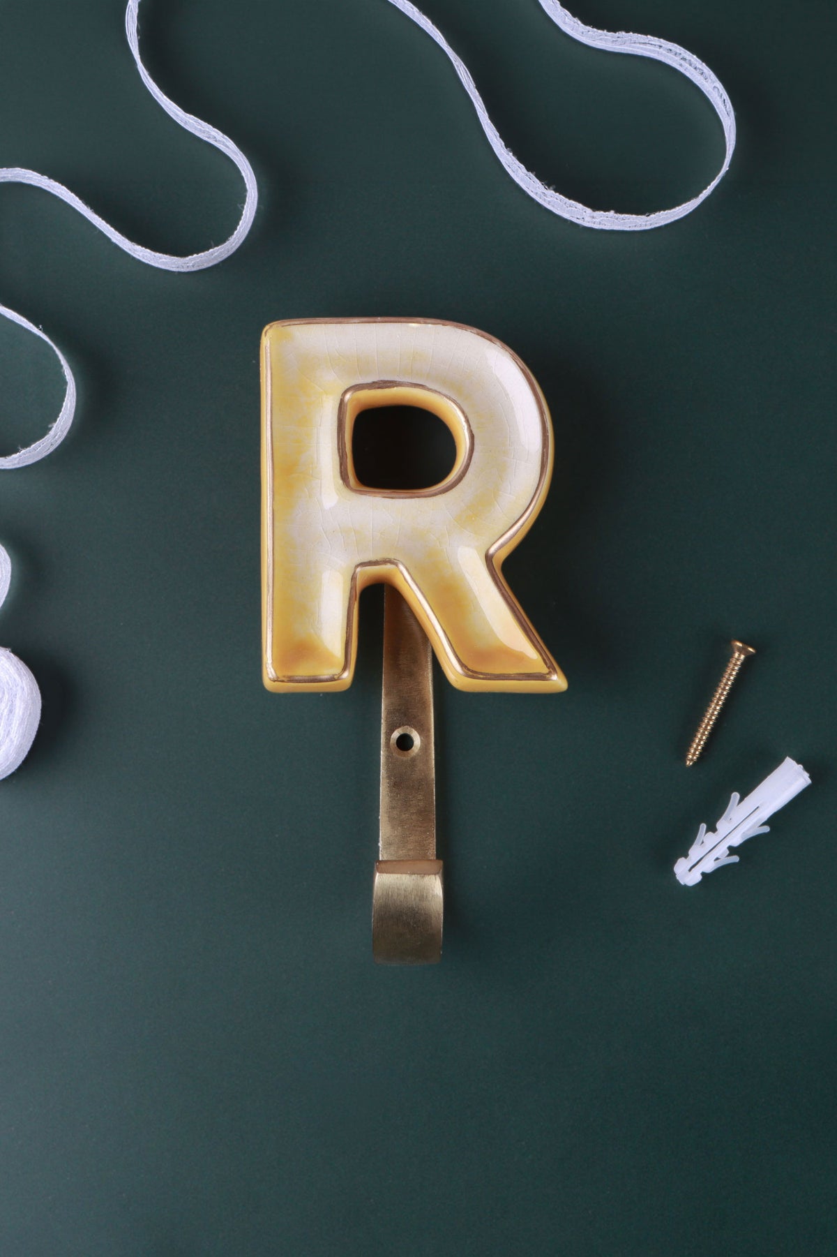 Yellow ceramic letter hook R with a gold rim