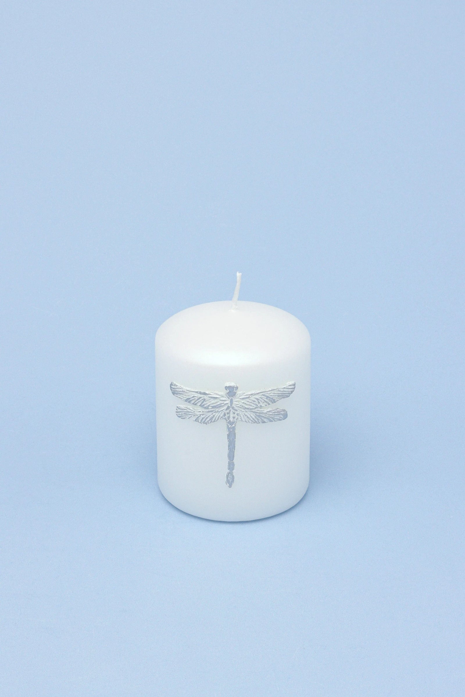 Dragonfly Queen White Pillar Candle with Silver Emblem — close-up view, G Decor