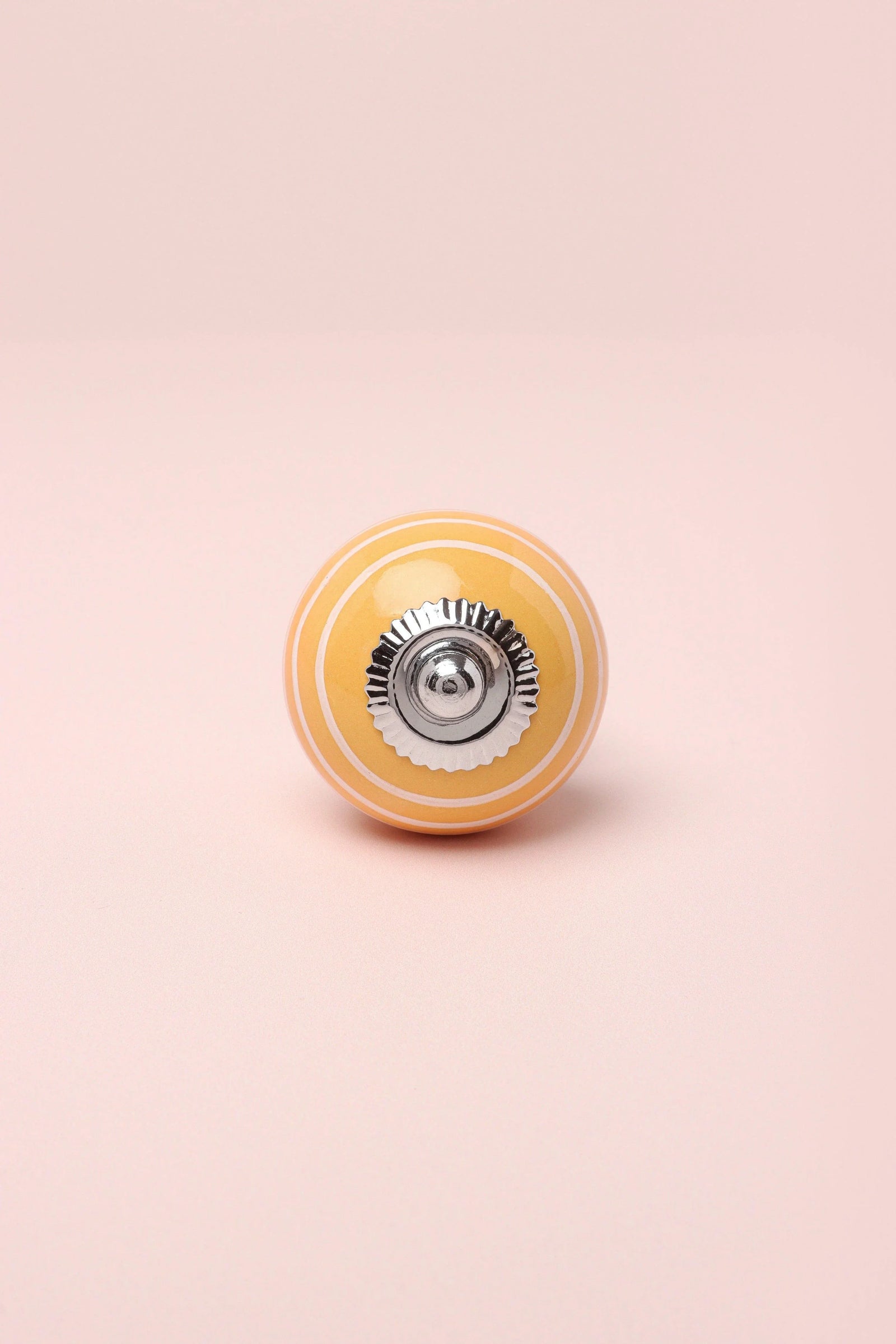 White Striped Hand-Painted Ceramic Cabinet Knob in Pink and Yellow — close-up view, G Decor
