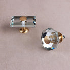 Octagon and rectangle clear crystal glass knobs from above, showing the bevelled edges and brass caps