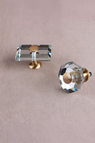 Octagon and rectangle clear crystal glass knobs from above, showing the bevelled edges and brass caps