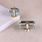 Clear crystal glass cabinet knobs on satin brass bases, in octagon and rectangle shapes