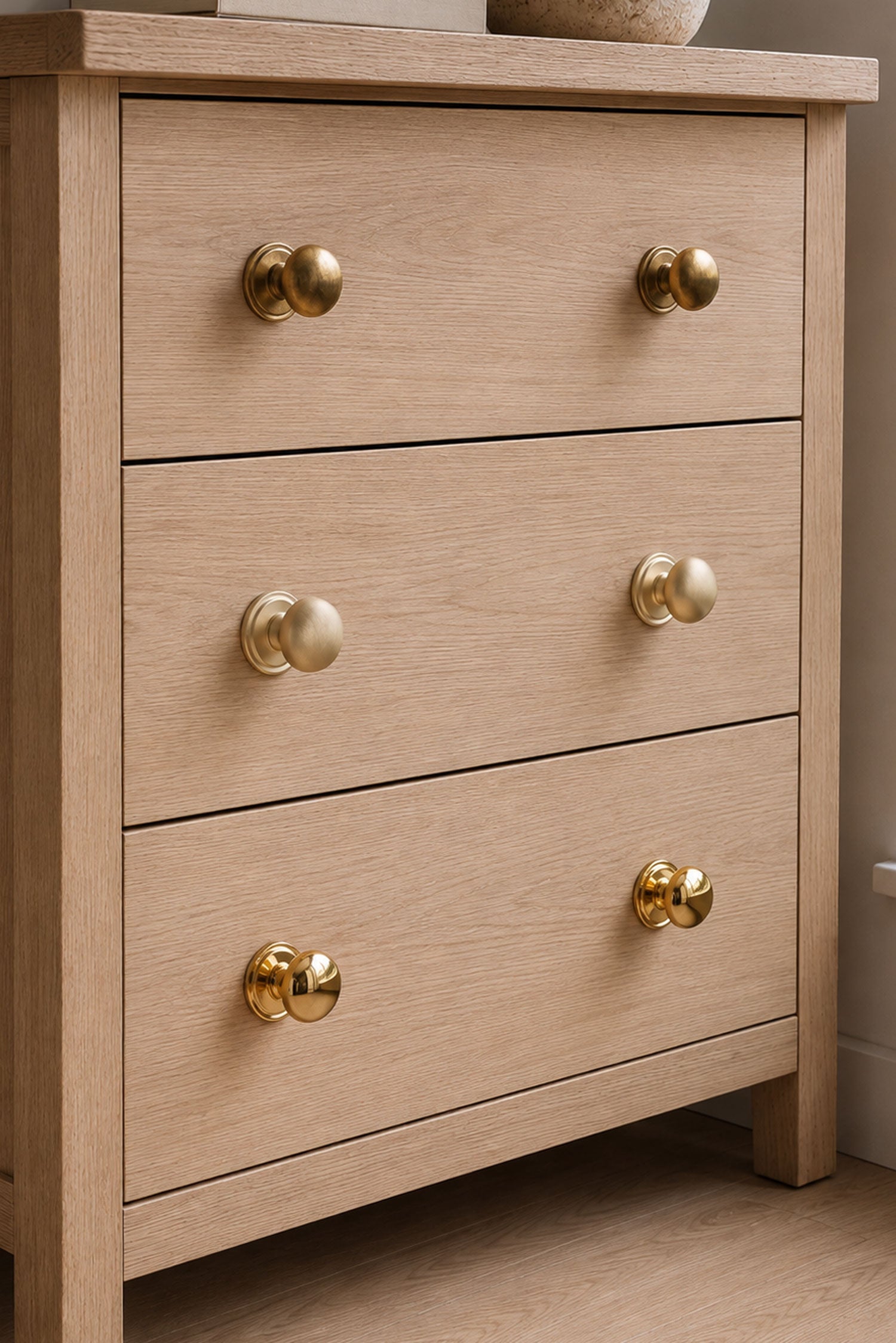 Bun cabinet knobs grouped, showing the low dome and stepped rose