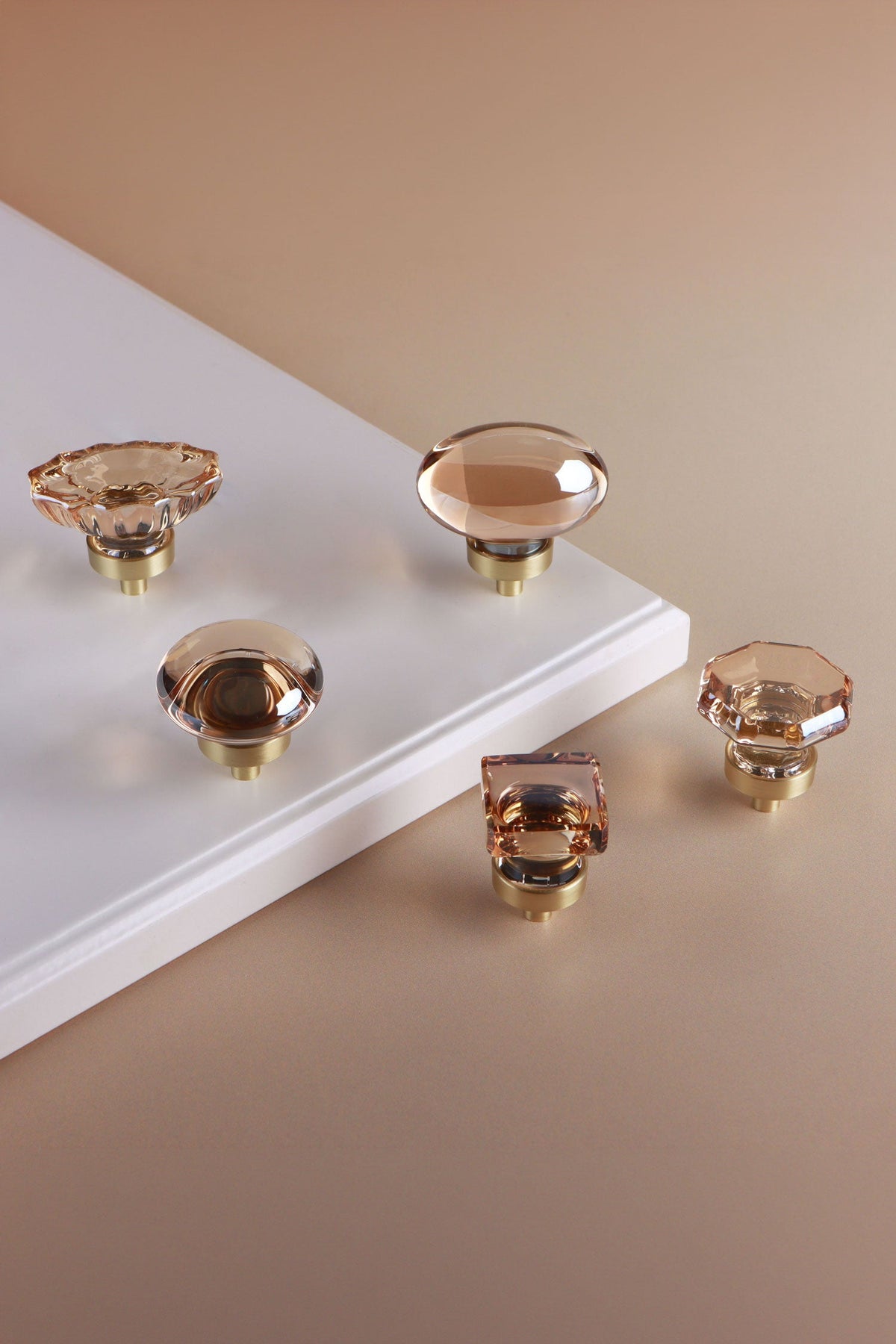Champagne crystal glass cabinet knob collection on a neutral background