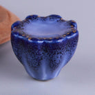 Cobalt blue fluted ceramic drawer knob with a speckled scalloped rim and gold-coloured dots