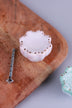 Pale pink scalloped ceramic drawer knob with gold-coloured dots, beside its M4 bolt