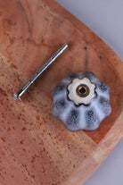 Underside of the black ceramic knob showing the threaded insert that takes the M4 bolt