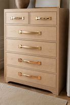 Brass pull handles fitted to a chest of drawers