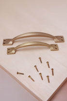 Cupboard pull handle in satin brass, both sizes with solid brass screws