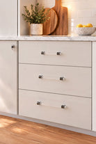 Crystal bar pull handles in polished chrome fitted to cream kitchen drawers