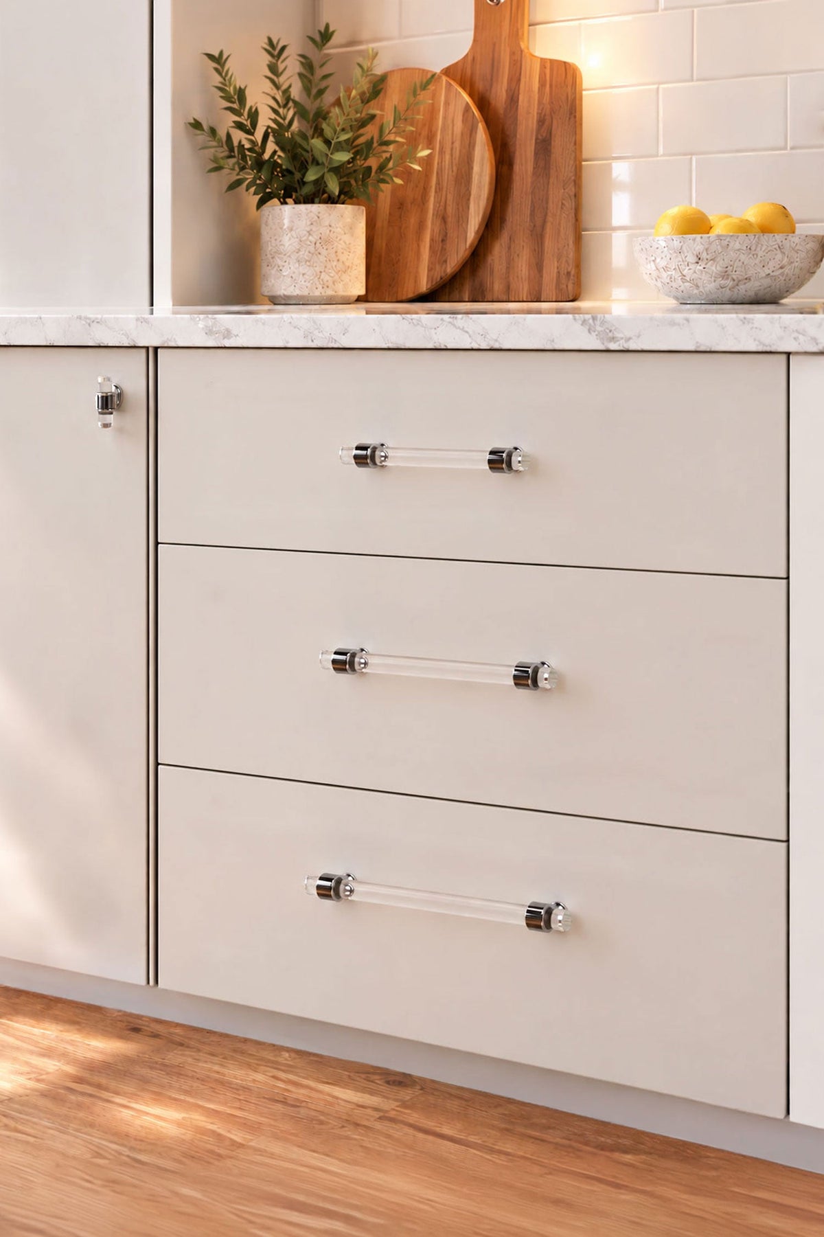 Crystal bar pull handles in polished chrome fitted to cream kitchen drawers