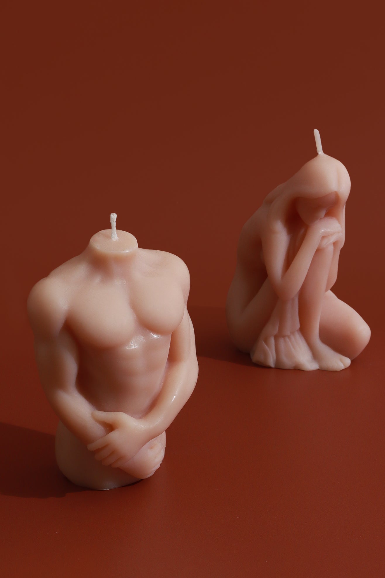 Muscular Male Torso and Crouching Female Candles