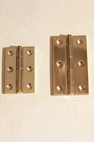 Polished brass butt hinges, both sizes side by side