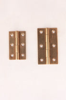 Aged brass butt hinges, both sizes side by side