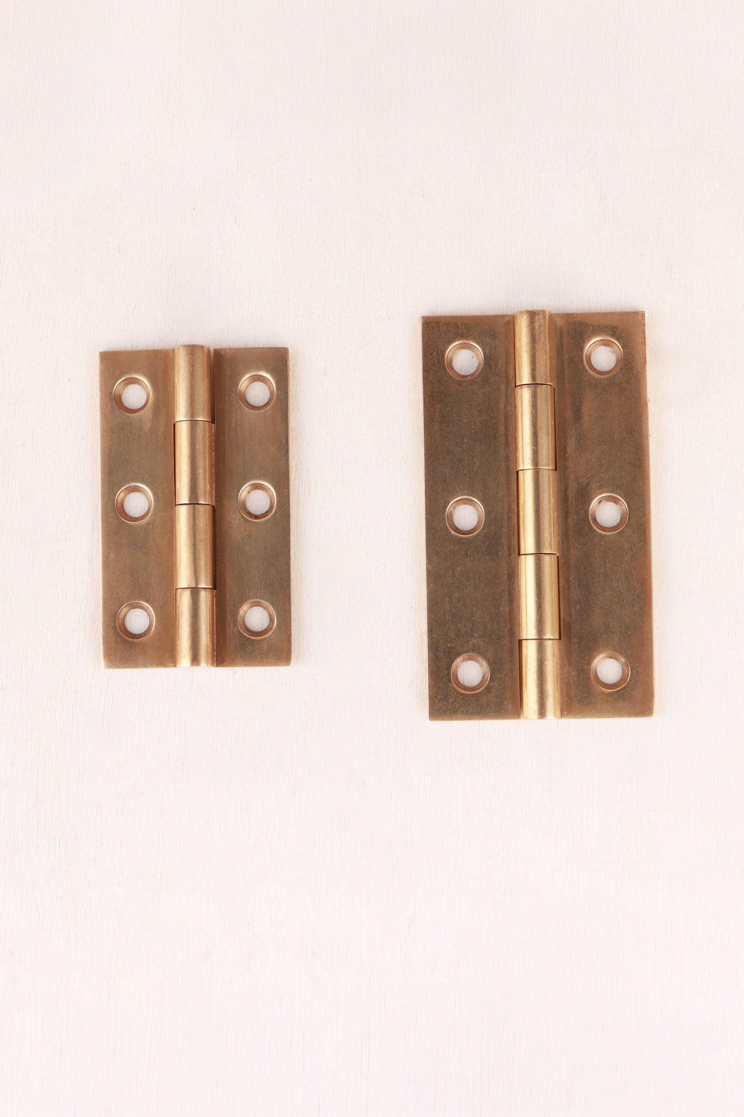 Aged brass butt hinges, both sizes side by side