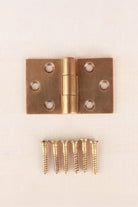 Backflap hinge in aged brass, unlacquered living finish