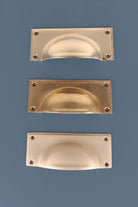 Three finishes of the Rounded Plate cup pull side by side
