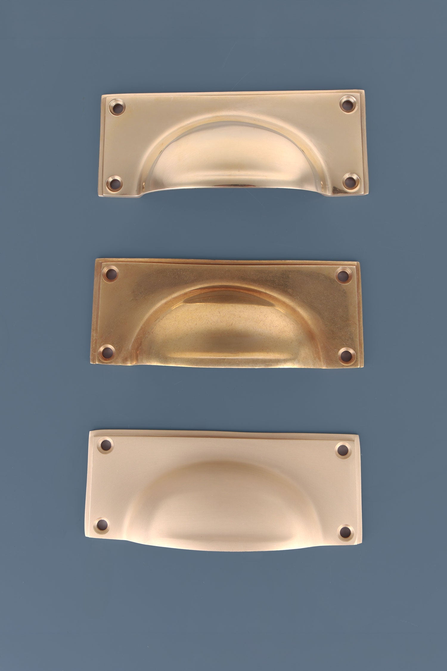 Three finishes of the Rounded Plate cup pull side by side
