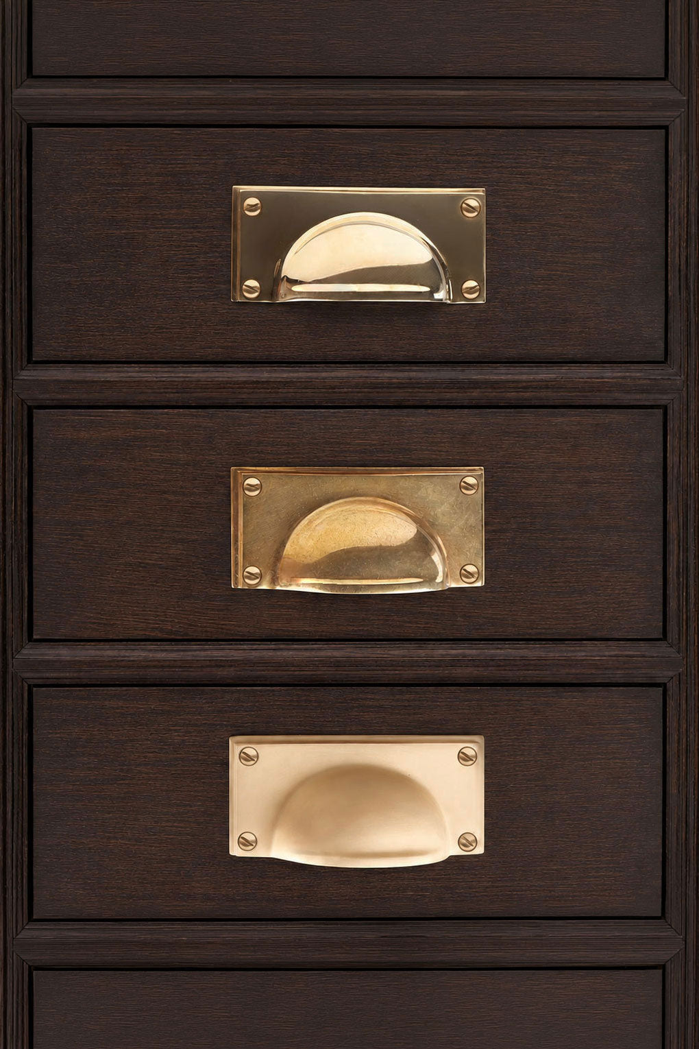 Rounded Plate solid brass cup pull, shown in polished, aged and satin brass