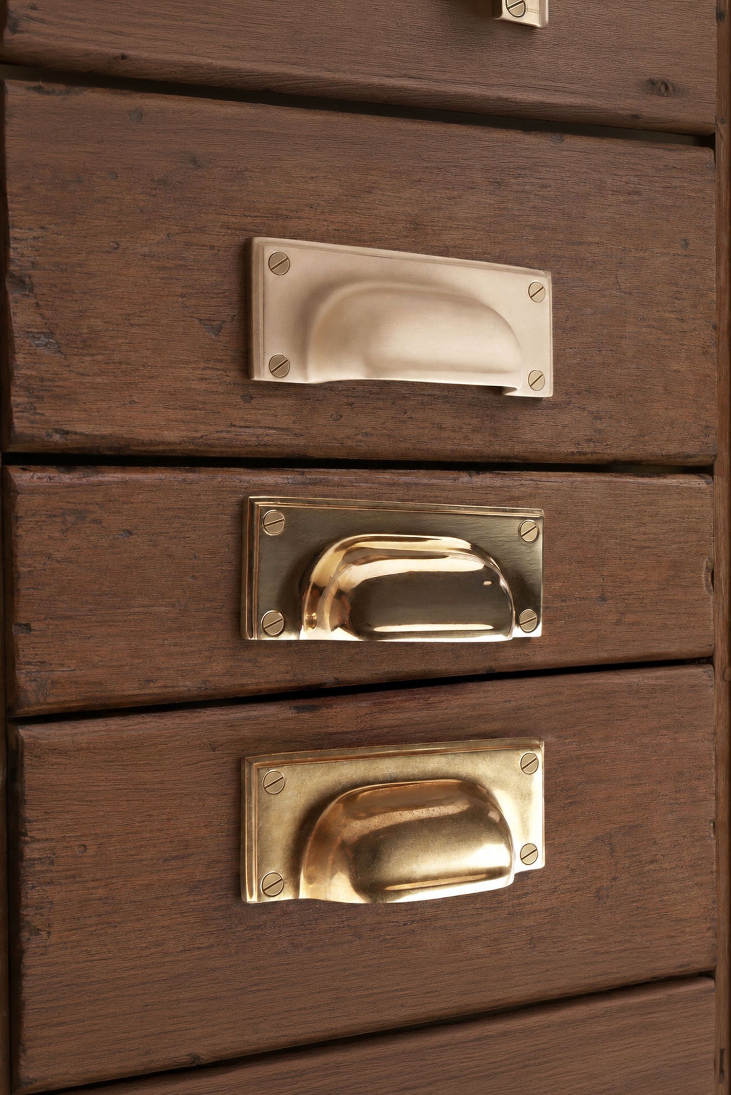 Square Plate solid brass cup pull, shown in polished, aged and satin brass