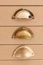 Half Moon solid brass cup pull, shown in polished, aged and satin brass