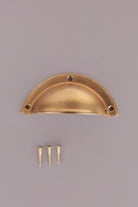 Half Moon cup pull in aged brass, unlacquered living finish