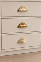 Three finishes of the Scalloped cup pull side by side