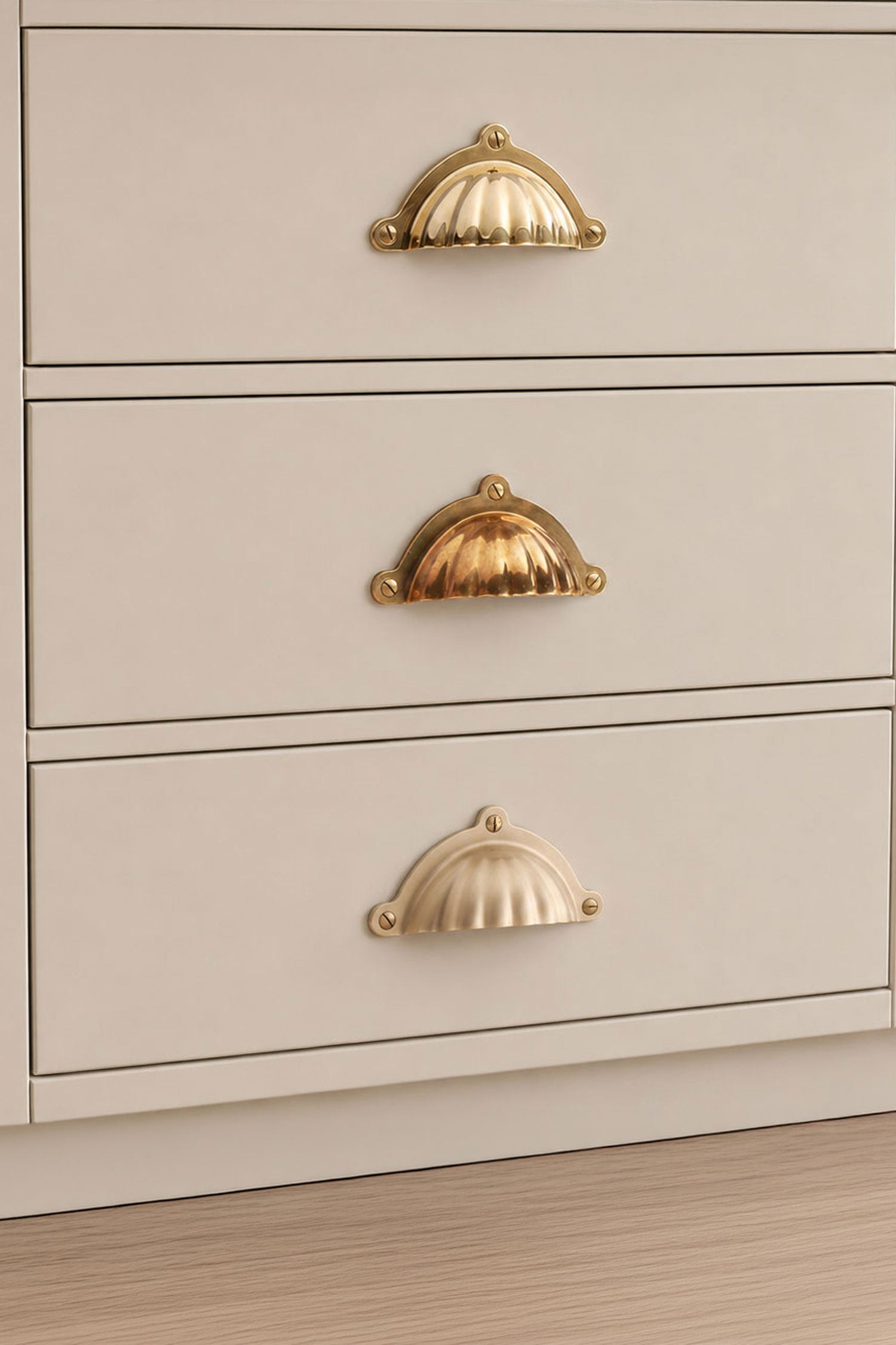Three finishes of the Scalloped cup pull side by side