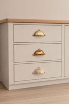 Scalloped solid brass cup pull, shown in polished, aged and satin brass
