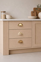 Fluted solid brass cup pull, shown in polished, aged and satin brass