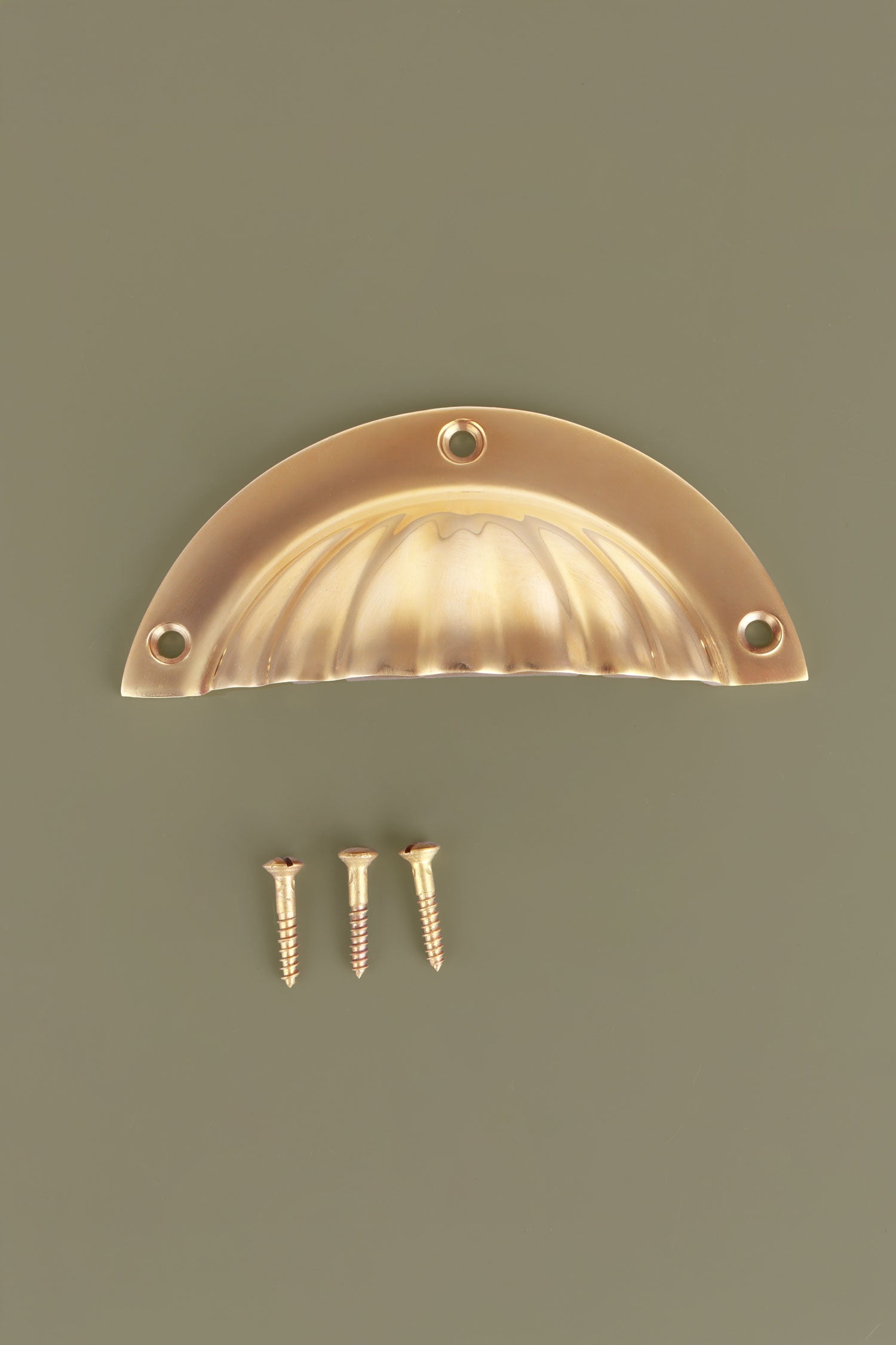 Fluted cup pull in polished brass, unlacquered living finish