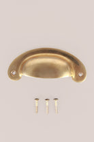 Slim Crescent cup pull in aged brass, unlacquered living finish
