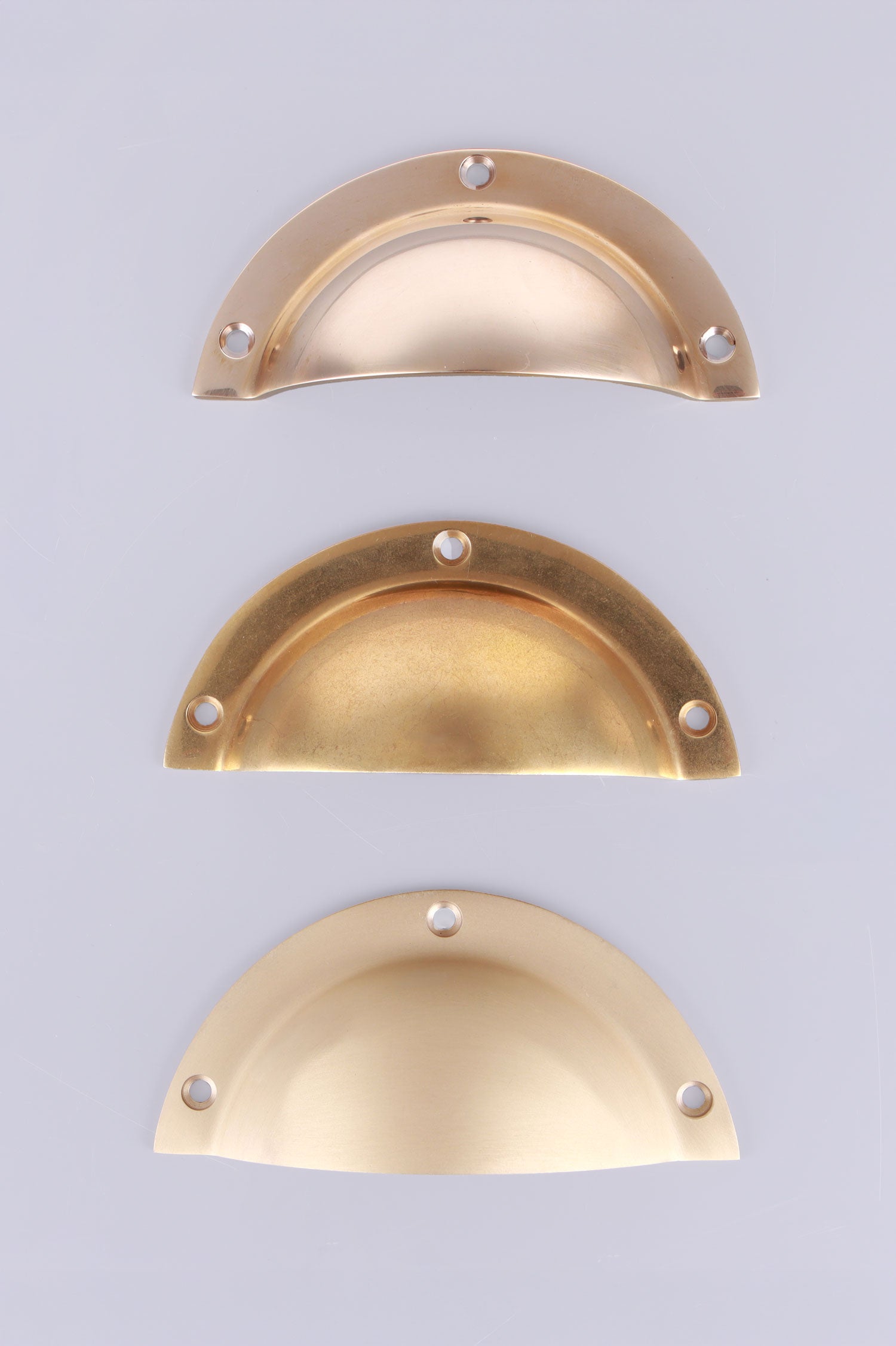 Stepped Rim brass cup pulls grouped, showing the broad stepped flange