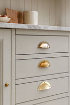 Stepped Rim solid brass cup pull, shown in polished, aged and satin brass