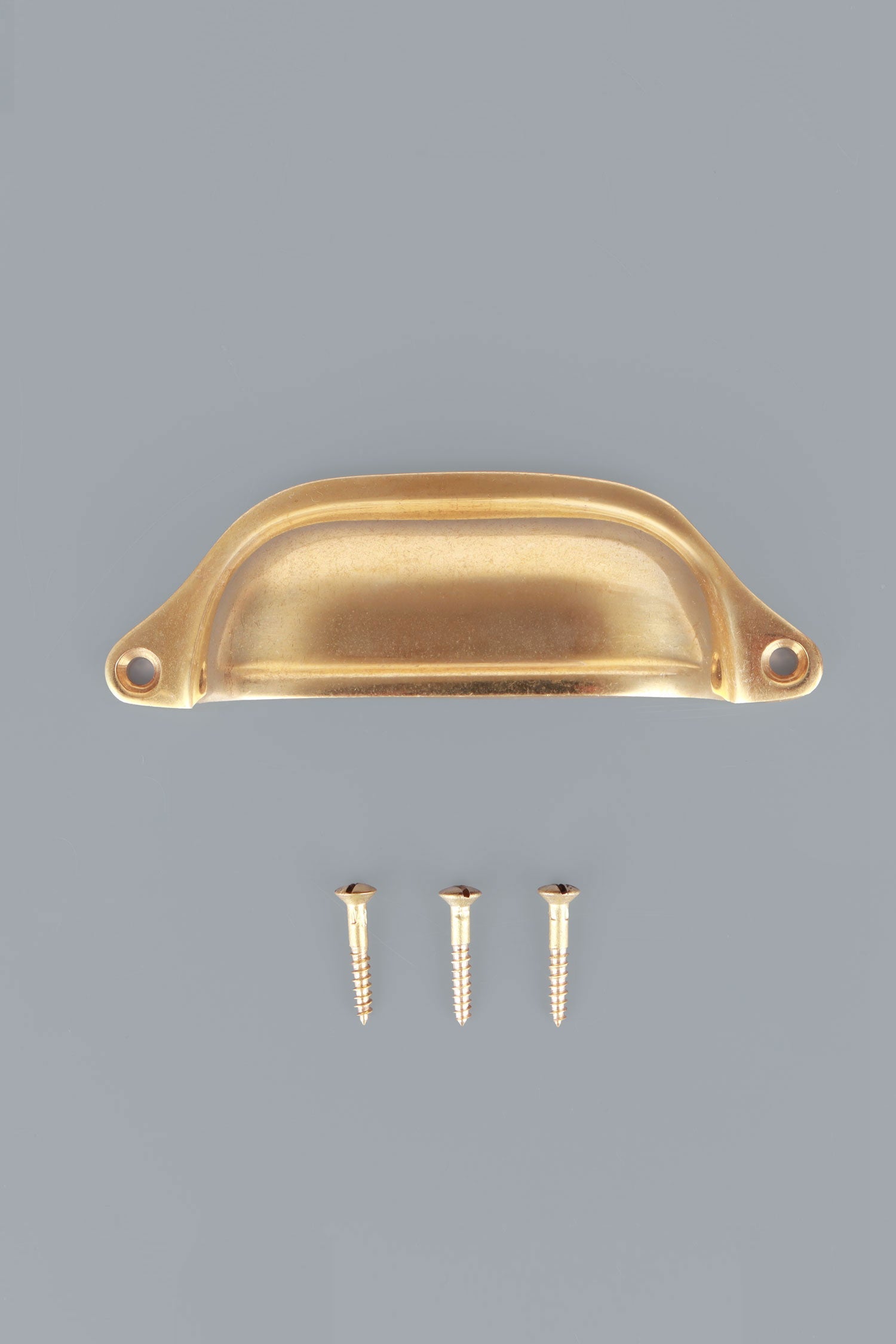 Deep Scoop cup pull in aged brass, unlacquered living finish