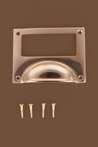 Card frame cup pull in polished brass, with a label window above the cup