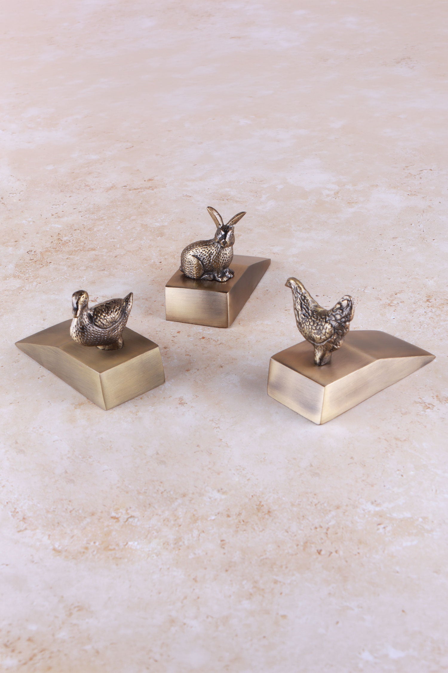 The three Homestead animal door stoppers together, antique brass