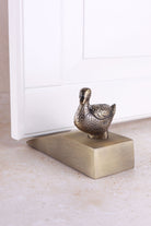Duck door stopper in antique brass