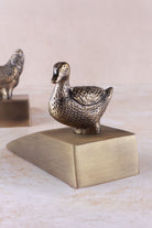 Duck door stopper in antique brass, side view