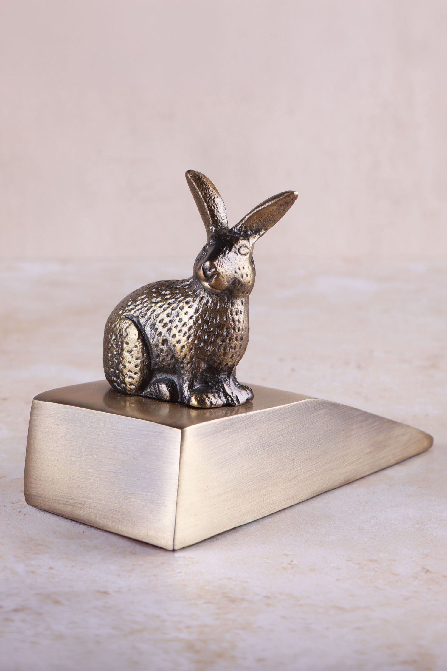 Rabbit door stopper in antique brass, side view