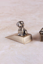 Dog door stopper in antique brass, side view