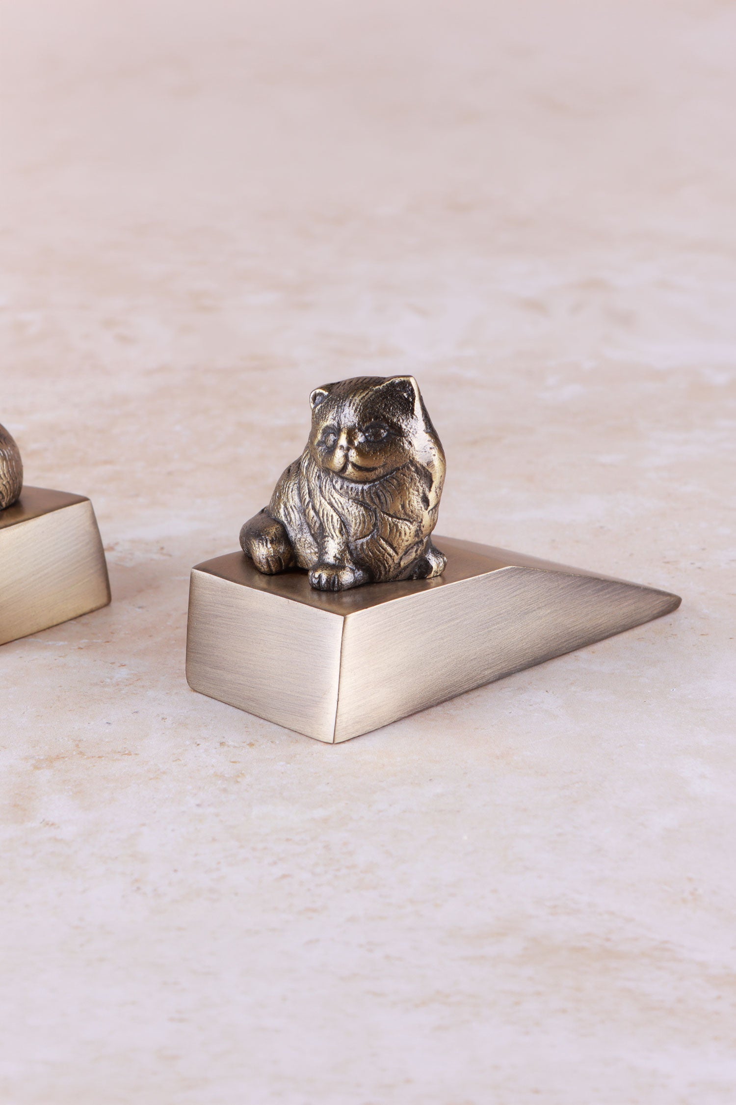 Cat door stopper in antique brass, side view