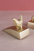 Hen door stopper in polished brass, side view