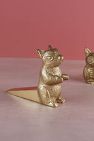Squirrel door stopper in polished brass, side view