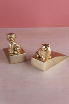 Companion cat and dog door stoppers in polished brass