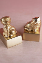 Cat and dog door stoppers in polished brass shown together
