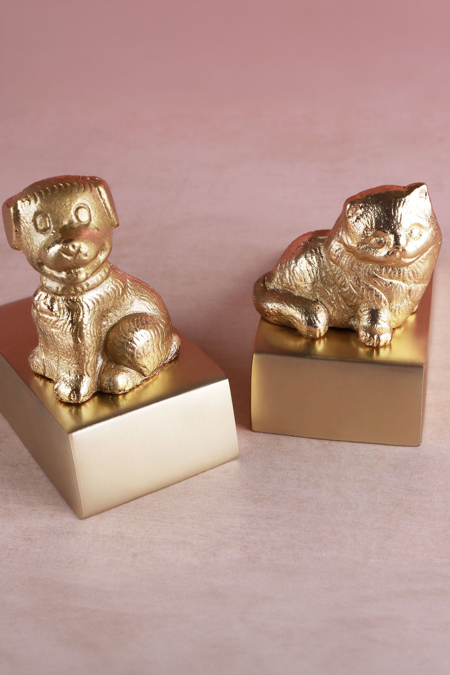 Cat and dog door stoppers in polished brass shown together