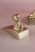 Dog door stopper in polished brass, close detail of the cast figure